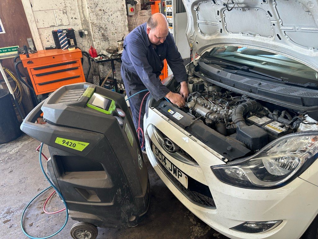 Air-con regassing machine connected to a car at Bankside MOT & Repair