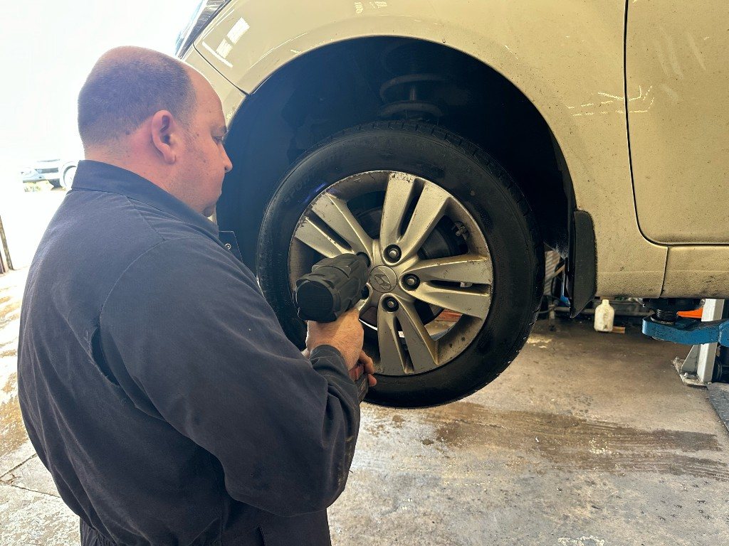 Mechanic using an impact wrench on a wheel at Bankside MOT & Repair